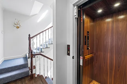 a view of an empty room with a window and a flat screen tv
