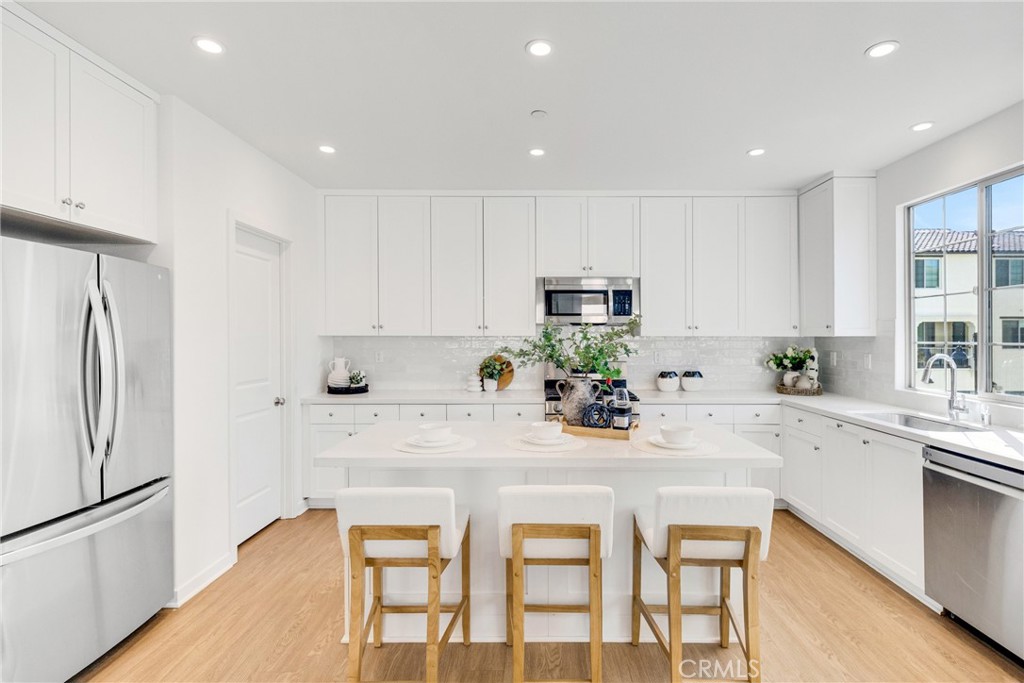 716 Spring Garden Irvine, CA 92618 - Photo 19 of 44 a kitchen with appliances a sink and cabinets