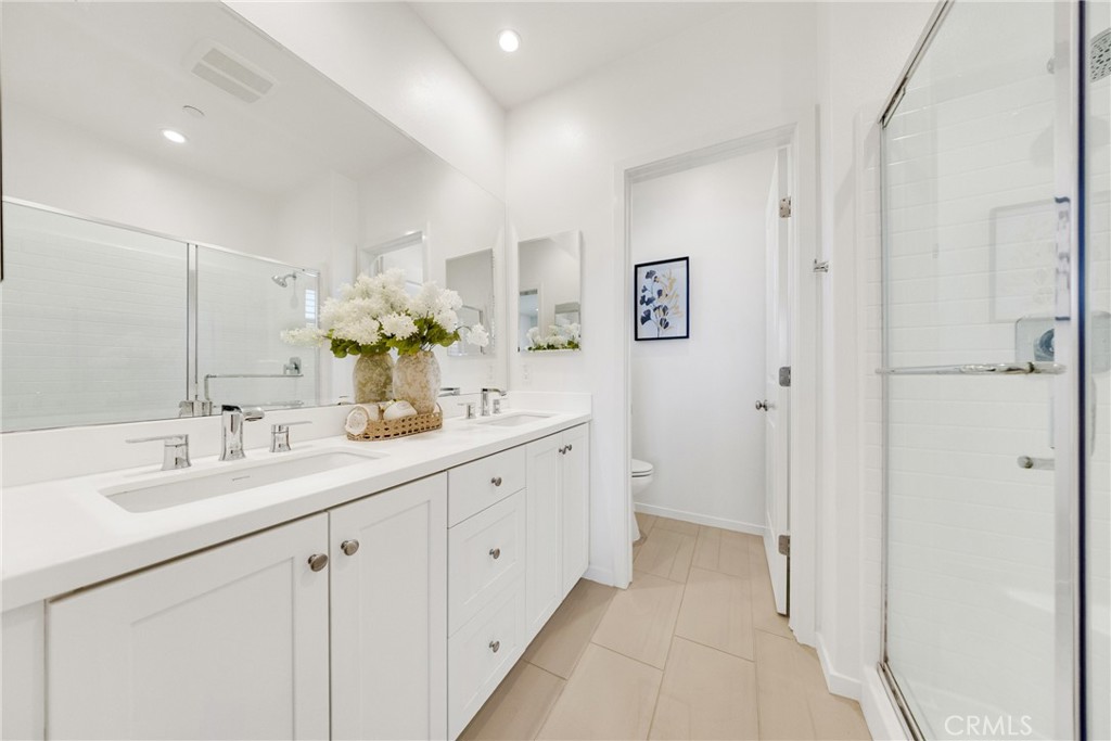 716 Spring Garden Irvine, CA 92618 - Photo 30 of 44 a spacious bathroom with a double vanity sink mirror and