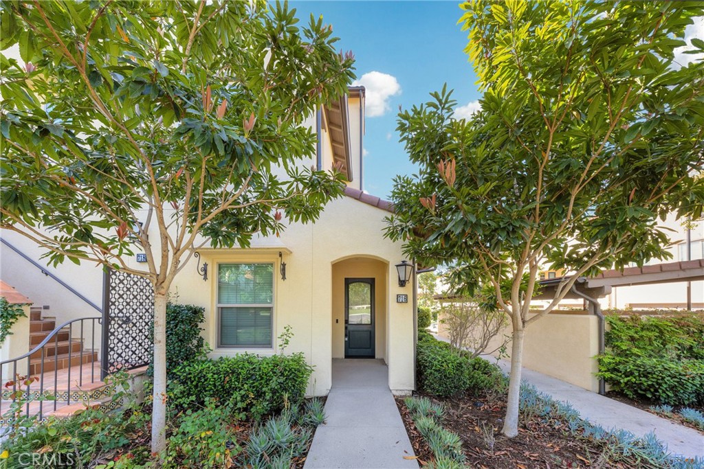 716 Spring Garden Irvine, CA 92618 - Photo 3 of 44 a front view of a house with garden
