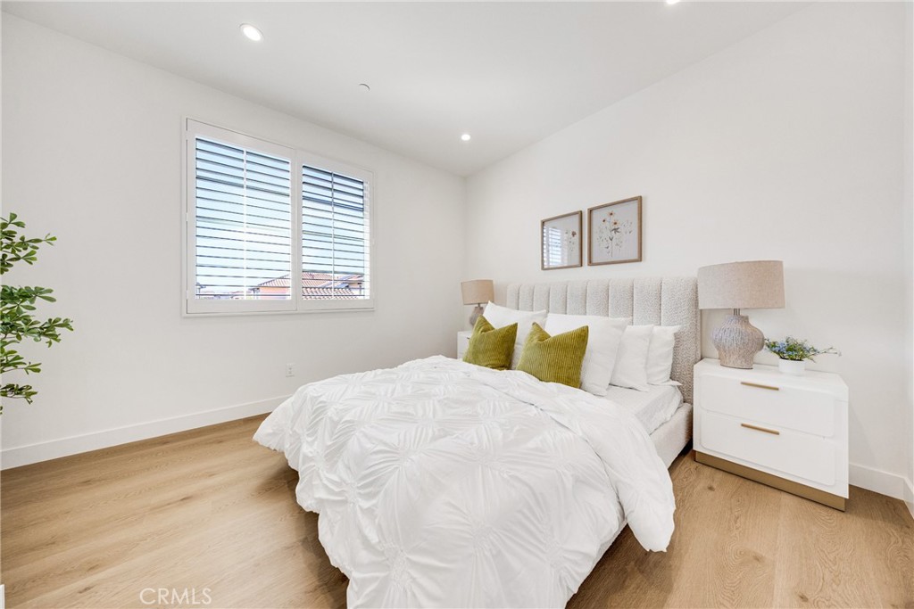 716 Spring Garden Irvine, CA 92618 - Photo 31 of 44 a bedroom with a bed and a night stand