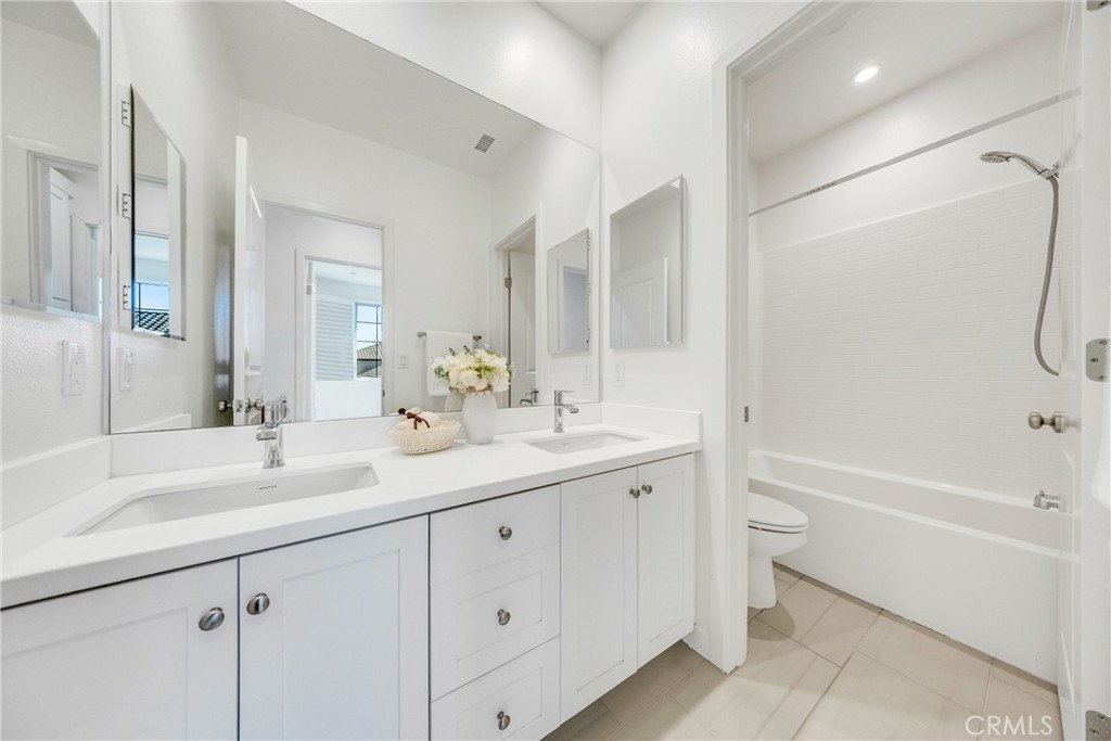 716 Spring Garden Irvine, CA 92618 - Photo 33 of 44 a bathroom with a sink double vanity granite tub shower and a mirror