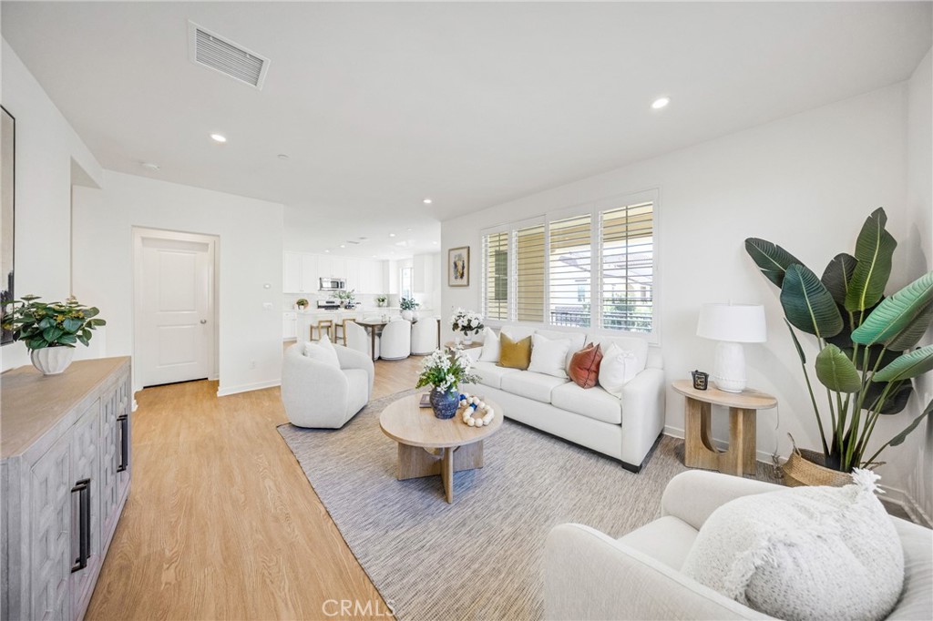 716 Spring Garden Irvine, CA 92618 - Photo 5 of 44 a living room with furniture and a potted plant