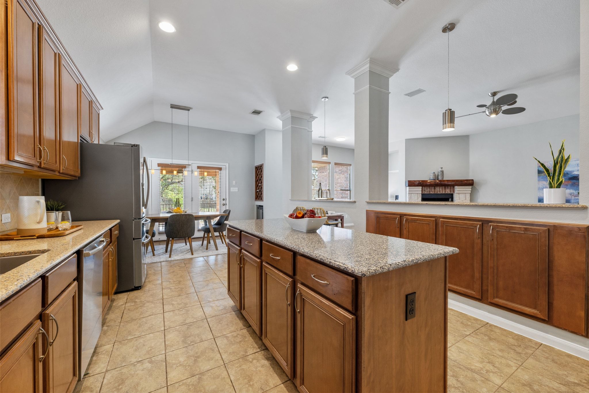 9905 Savannah Ridge Drive Austin, TX 78726 - Photo 15 of 35 Natural light from the breakfast area highlights the warm tile floors and makes the kitchen feel bright and welcoming