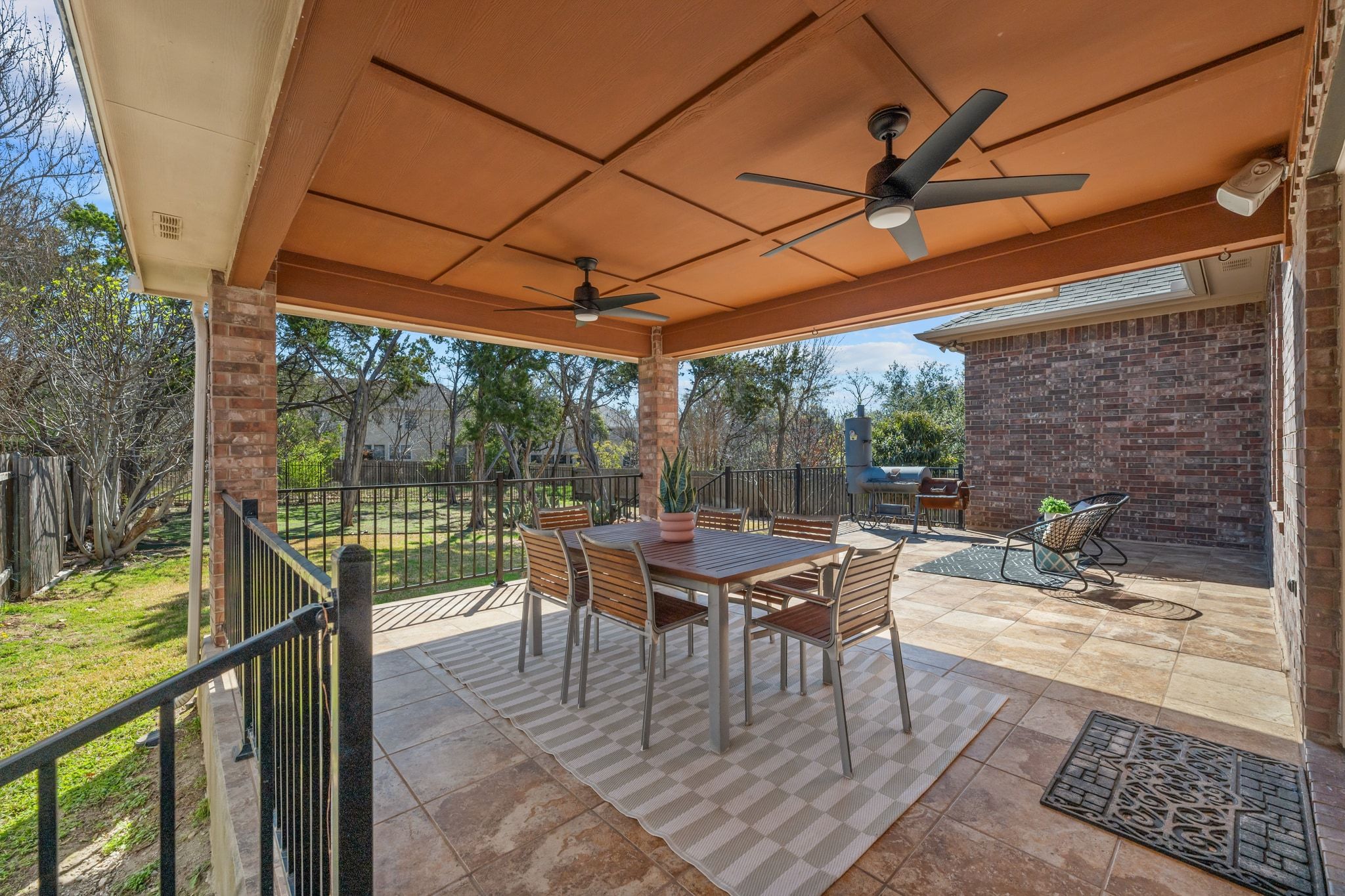 9905 Savannah Ridge Drive Austin, TX 78726 - Photo 28 of 35 The extended tile patio offers a massive footprint for an outdoor dining table and a full lounge setup
