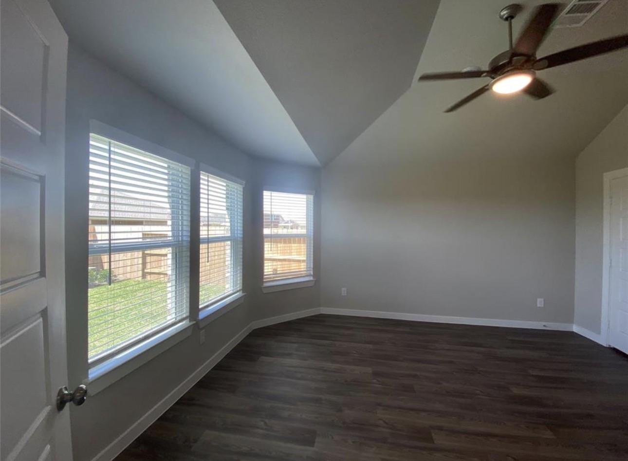 3119 Spanish Oak Lane Rosenberg, TX 77471 - Photo 11 of 18 an empty room with wooden floor and windows