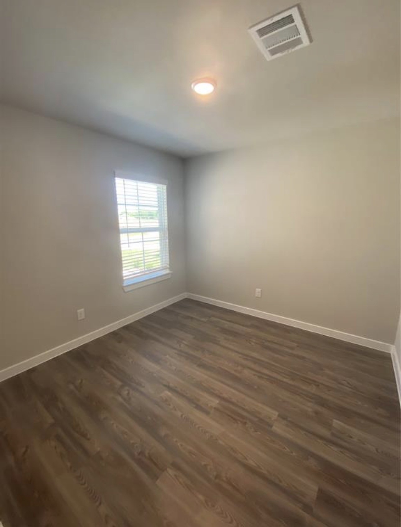 3119 Spanish Oak Lane Rosenberg, TX 77471 - Photo 17 of 18 an empty room with wooden floor and windows