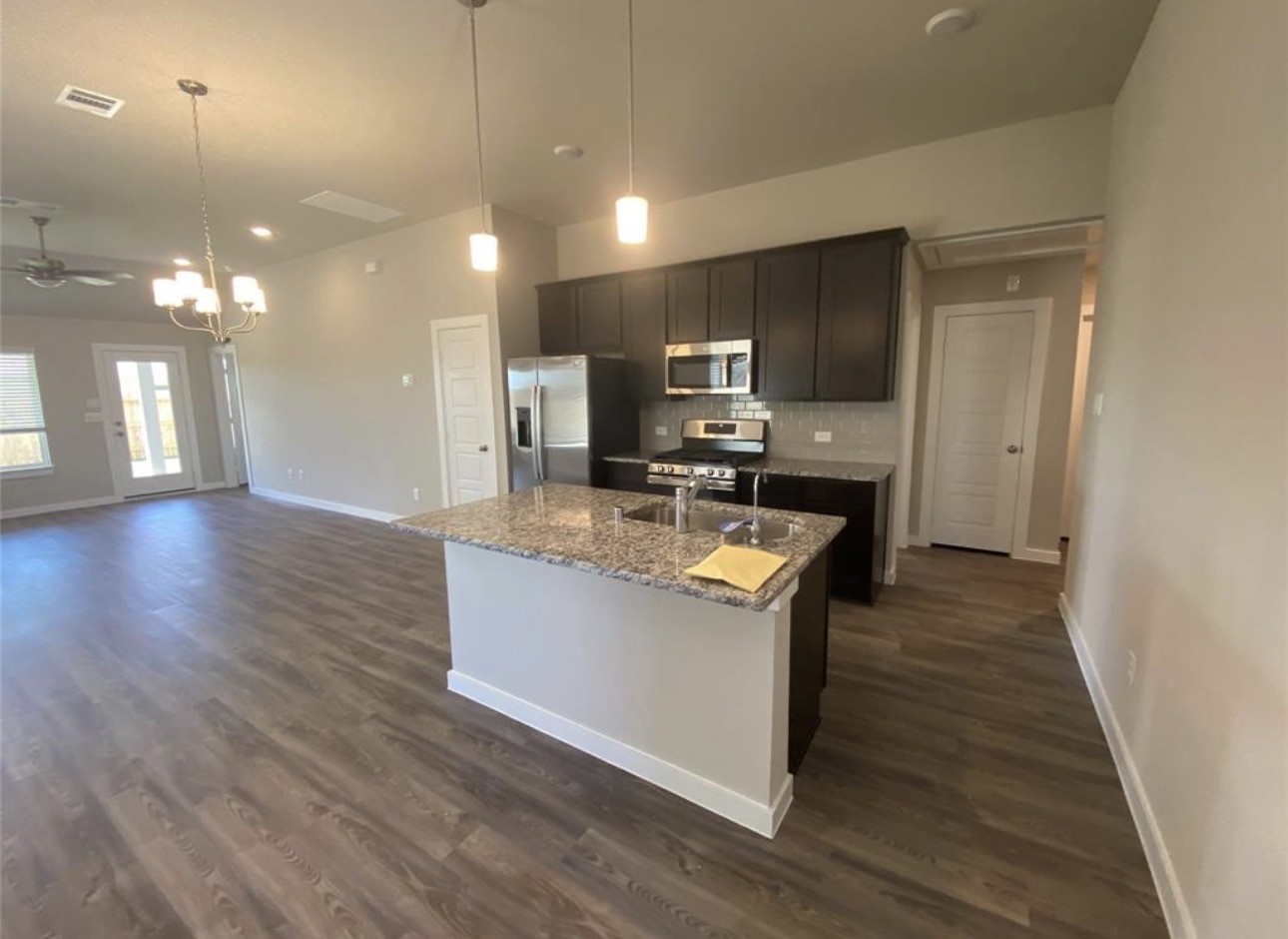 3119 Spanish Oak Lane Rosenberg, TX 77471 - Photo 6 of 18 a kitchen with kitchen island a sink stainless steel appliances and cabinets