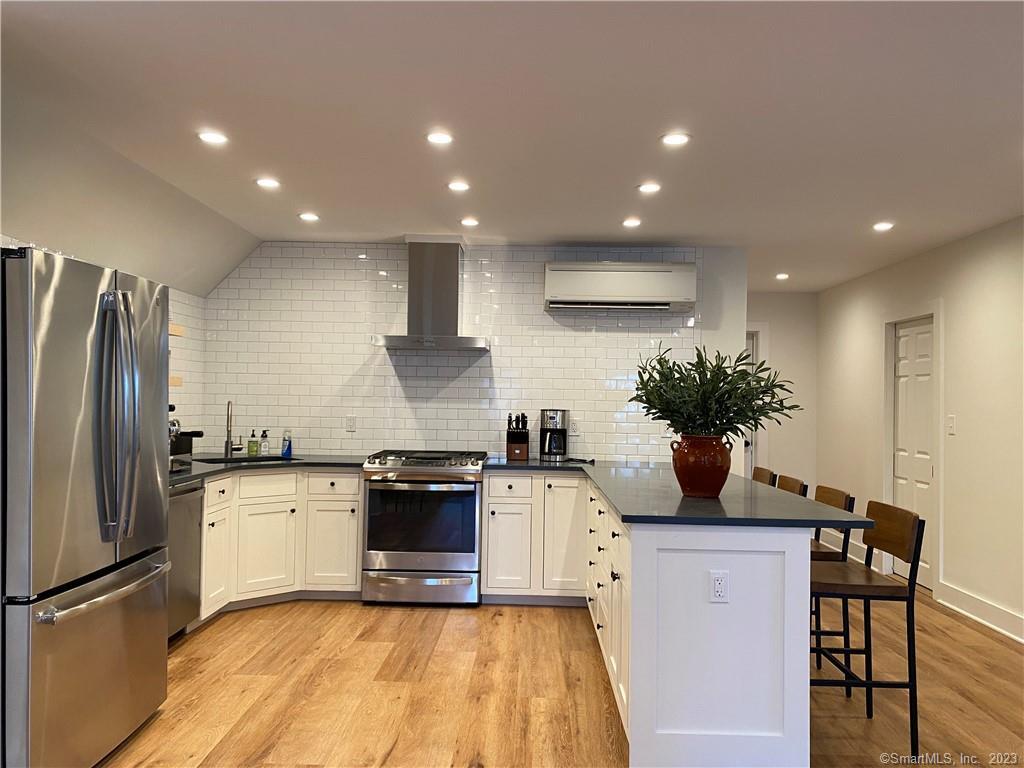 55 Still Meadow Road Sharon, CT 06069 - Photo 13 of 24 a kitchen with stainless steel appliances kitchen island granite countertop a sink a stove and a refrigerator