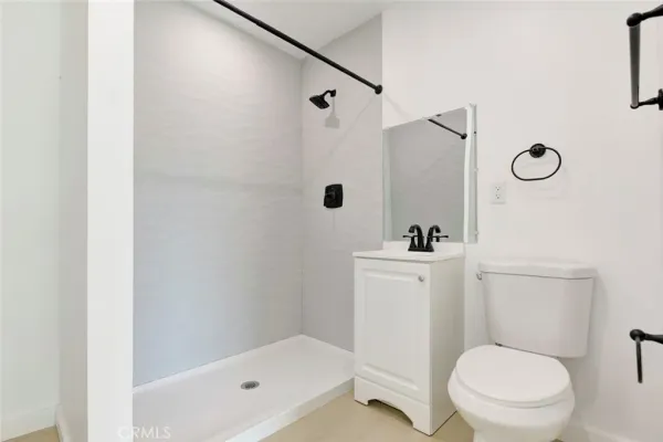 a white toilet sitting next to a bathroom sink and tub