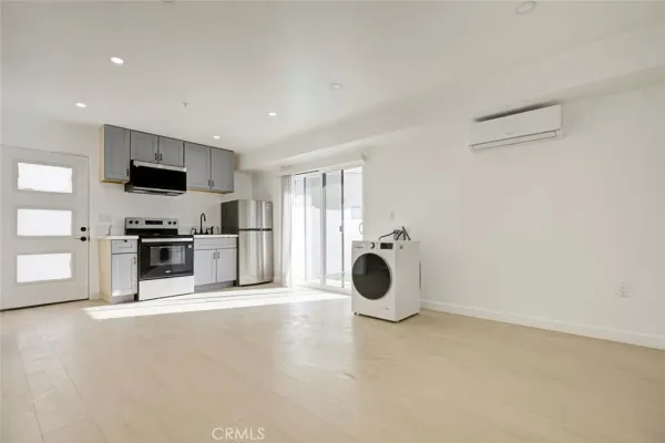 a kitchen with a sink and stainless steel appliances