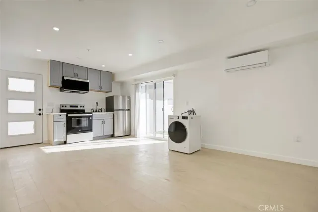 a kitchen with a sink and stainless steel appliances