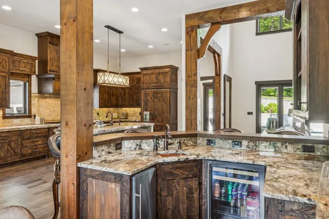 a bathroom with a granite countertop sink and a window