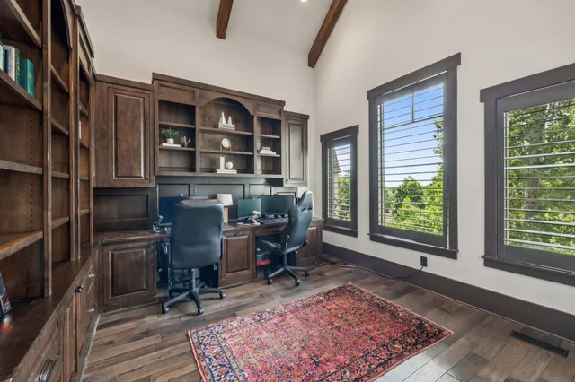 a living room with furniture and large windows
