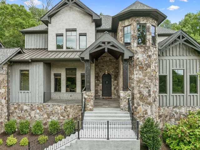 a front view of a house with a garden