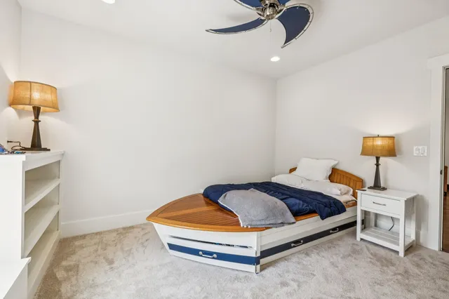 a bathroom with a granite countertop sink toilet mirror and shower
