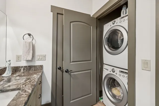a view of a room that has a bed wooden floor and a mirror
