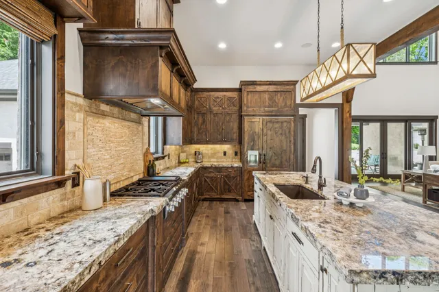 a kitchen with stainless steel appliances granite countertop a sink and cabinets