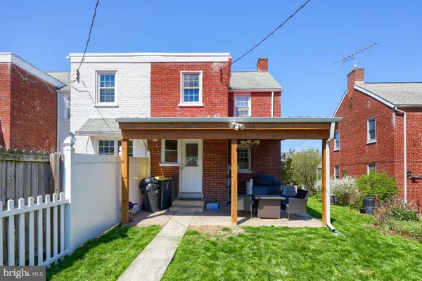 a front view of a house with a yard table and chairs