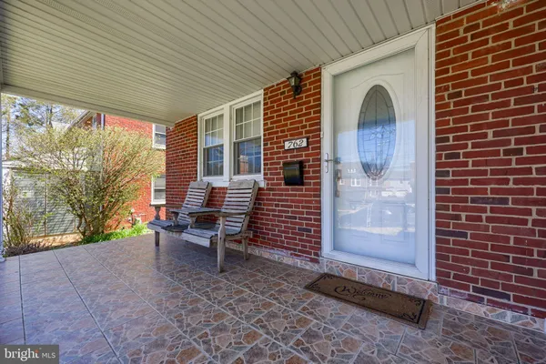 a backyard of a house with barbeque oven table and chairs