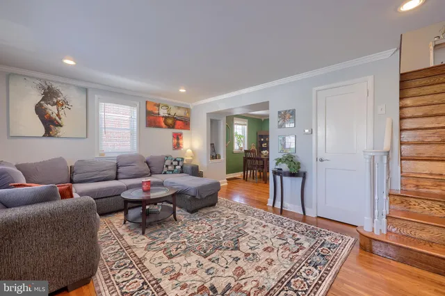a living room with furniture or couch and a wooden floor