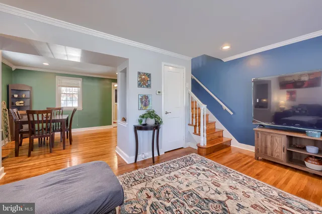 a living room with furniture and a dining table