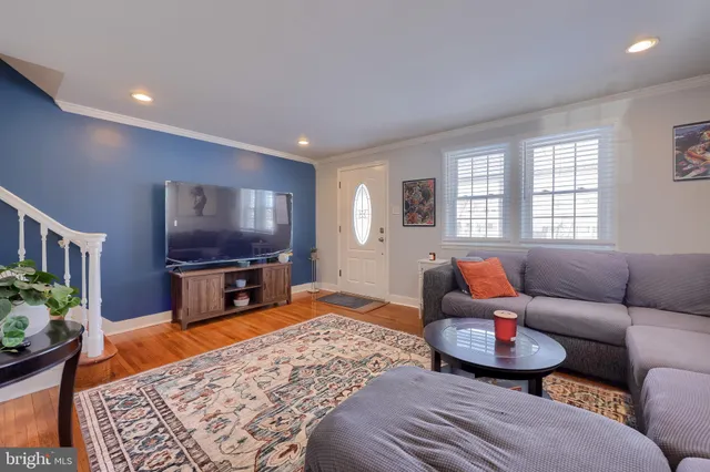 a living room with furniture a large window and a flat screen tv
