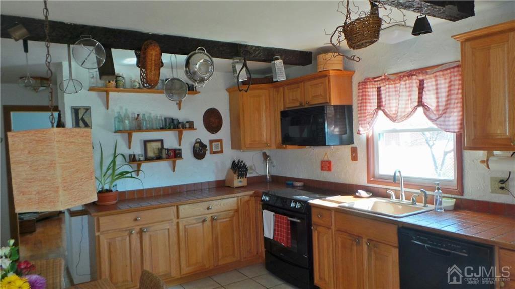 57 Orange Street Edison, NJ 08817 - Photo 4 of 15 a kitchen with a sink cabinets and window