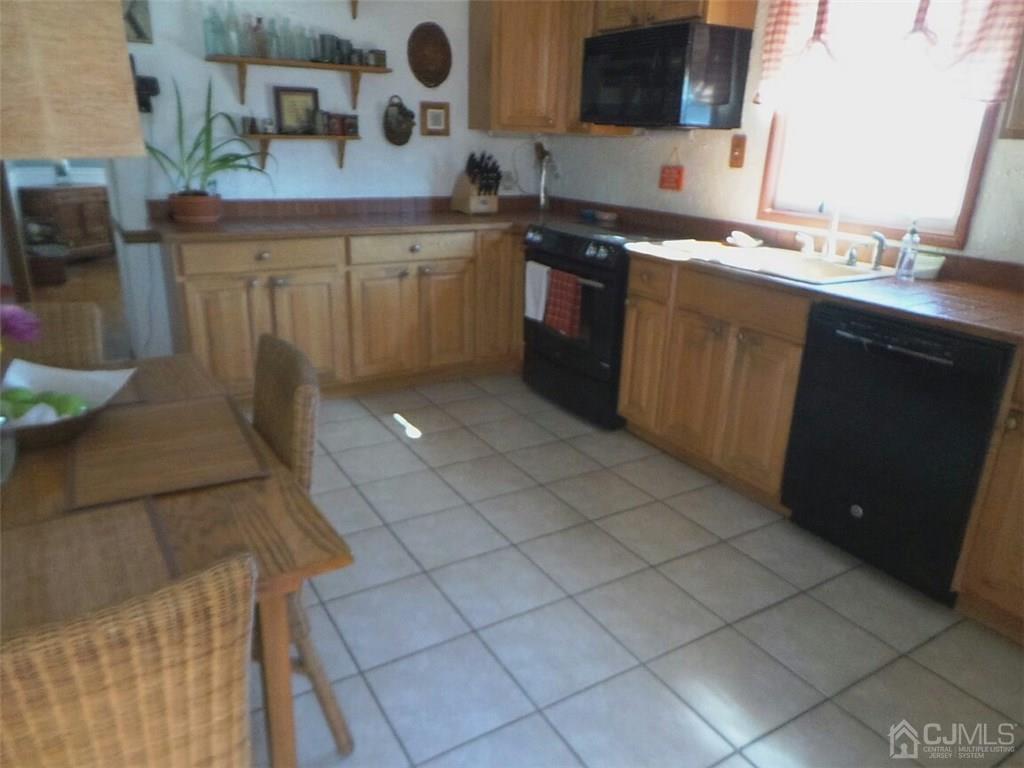 57 Orange Street Edison, NJ 08817 - Photo 5 of 15 a kitchen with a sink and cabinets