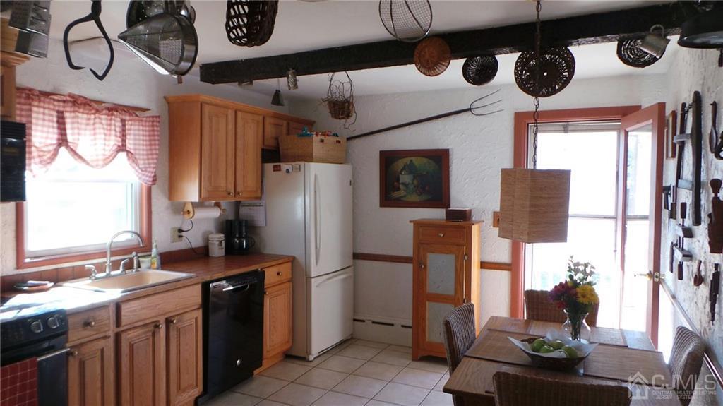 57 Orange Street Edison, NJ 08817 - Photo 6 of 15 a kitchen with stainless steel appliances granite countertop a sink a stove and a refrigerator