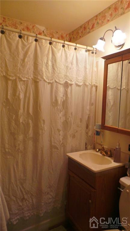 57 Orange Street Edison, NJ 08817 - Photo 8 of 15 a bathroom with a sink and mirror