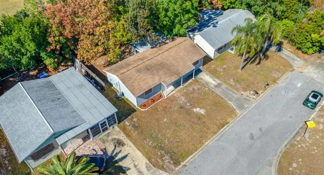 aerial view of a house with a yard and sitting space