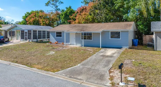 a view of a house with a backyard and windows