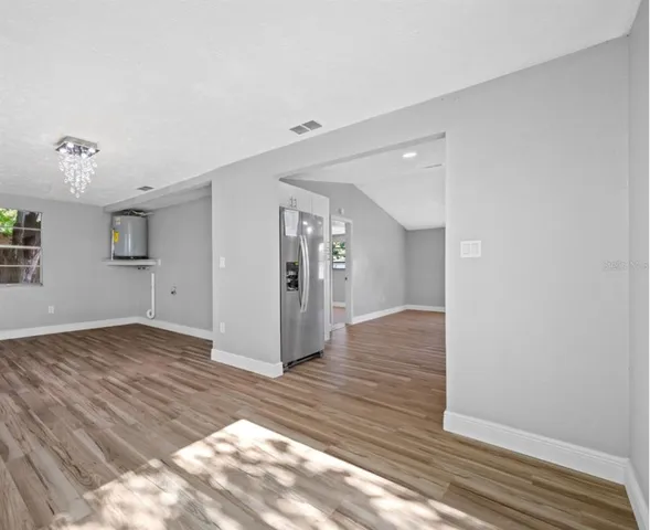 a view of an empty room and wooden floor