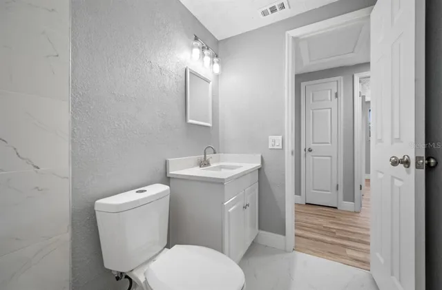 a bathroom with a toilet sink and shower