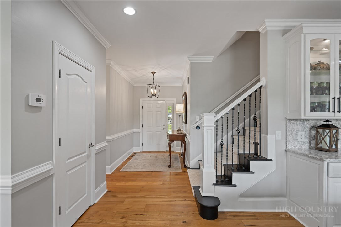 147 Riverside Park Court, Unit G2 Jefferson, NC 28640 - Photo 21 of 44 a view of a hallway with bathtub and chandelier