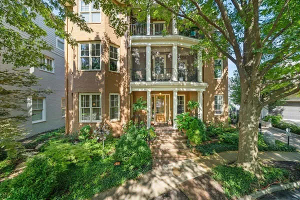 front view of a brick house with a yard