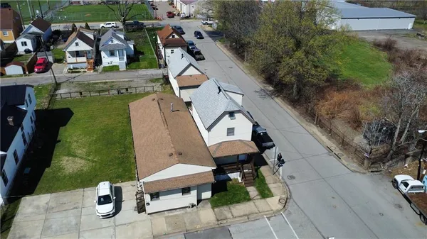 an aerial view of a house with garden space and street view