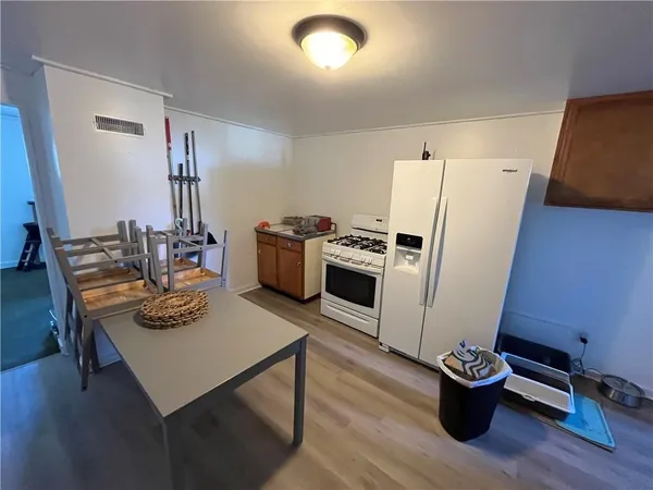 a kitchen with a refrigerator and a stove top oven