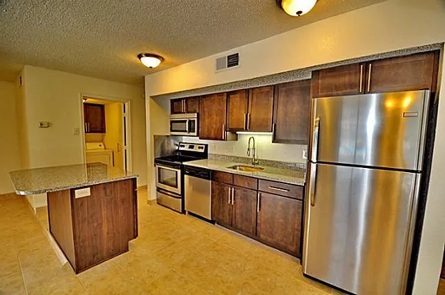 a kitchen with stainless steel appliances a refrigerator and a stove