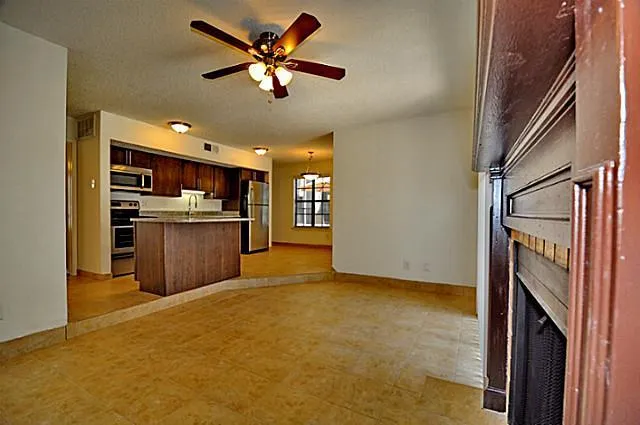 a view of a kitchen with a sink cabinets and ceiling fan