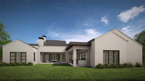 a front view of house with a garden and yard