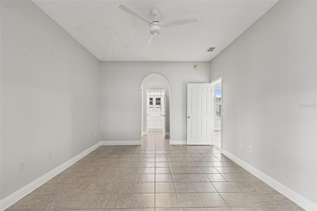 8433 Beachwood Court Spring Hill, FL 34606 - Photo 12 of 38 a view of a livingroom with wooden floor and white walls