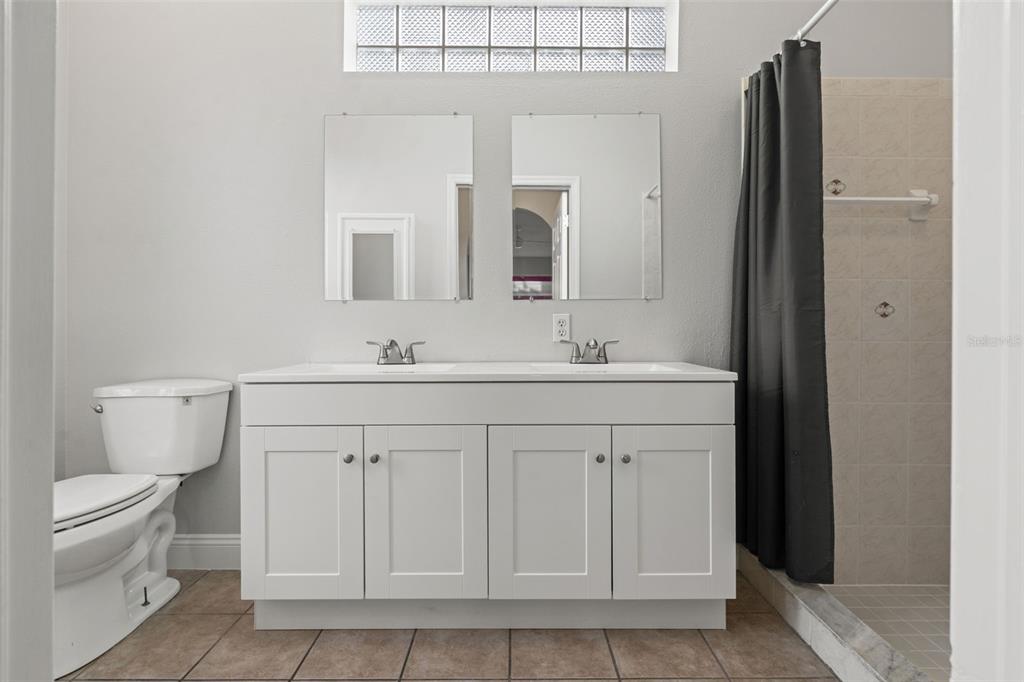 8433 Beachwood Court Spring Hill, FL 34606 - Photo 13 of 38 a bathroom with a sink vanity and a toilet