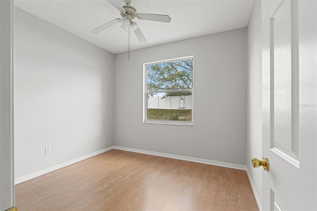 8433 Beachwood Court Spring Hill, FL 34606 - Photo 19 of 38 an empty room with a window and a fan