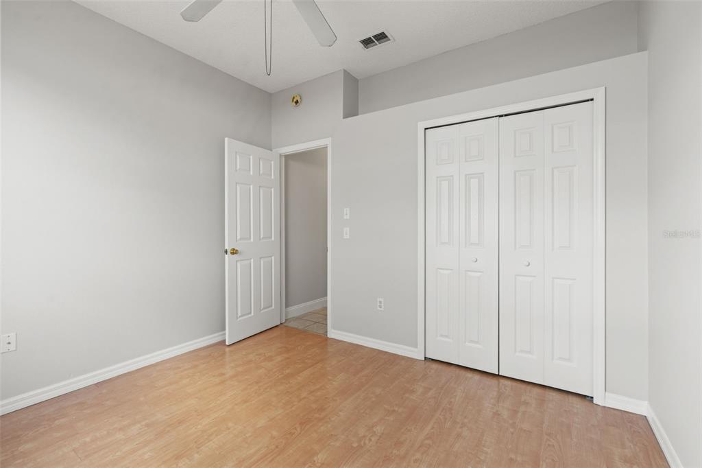 8433 Beachwood Court Spring Hill, FL 34606 - Photo 20 of 38 an empty room with a ceiling fan