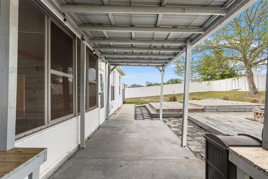 8433 Beachwood Court Spring Hill, FL 34606 - Photo 26 of 38 a view of a porch with a table and chairs
