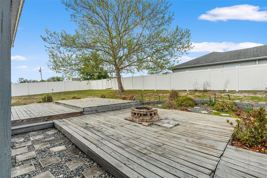 8433 Beachwood Court Spring Hill, FL 34606 - Photo 27 of 38 a view of a backyard with wooden floor and lake view