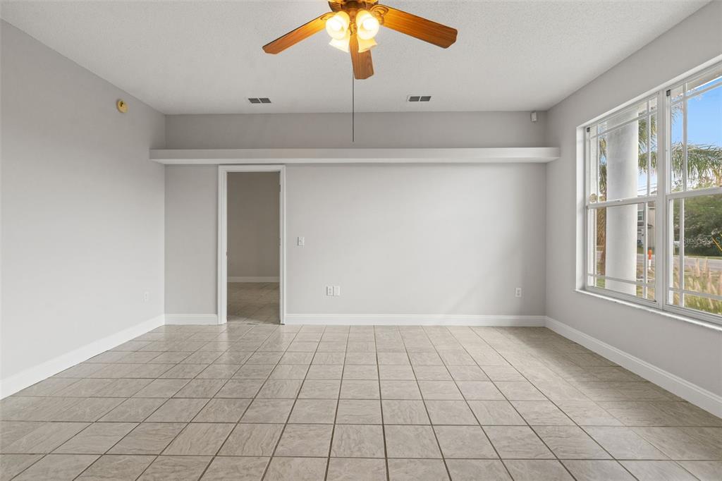 8433 Beachwood Court Spring Hill, FL 34606 - Photo 5 of 38 wooden floor in an empty room with a window