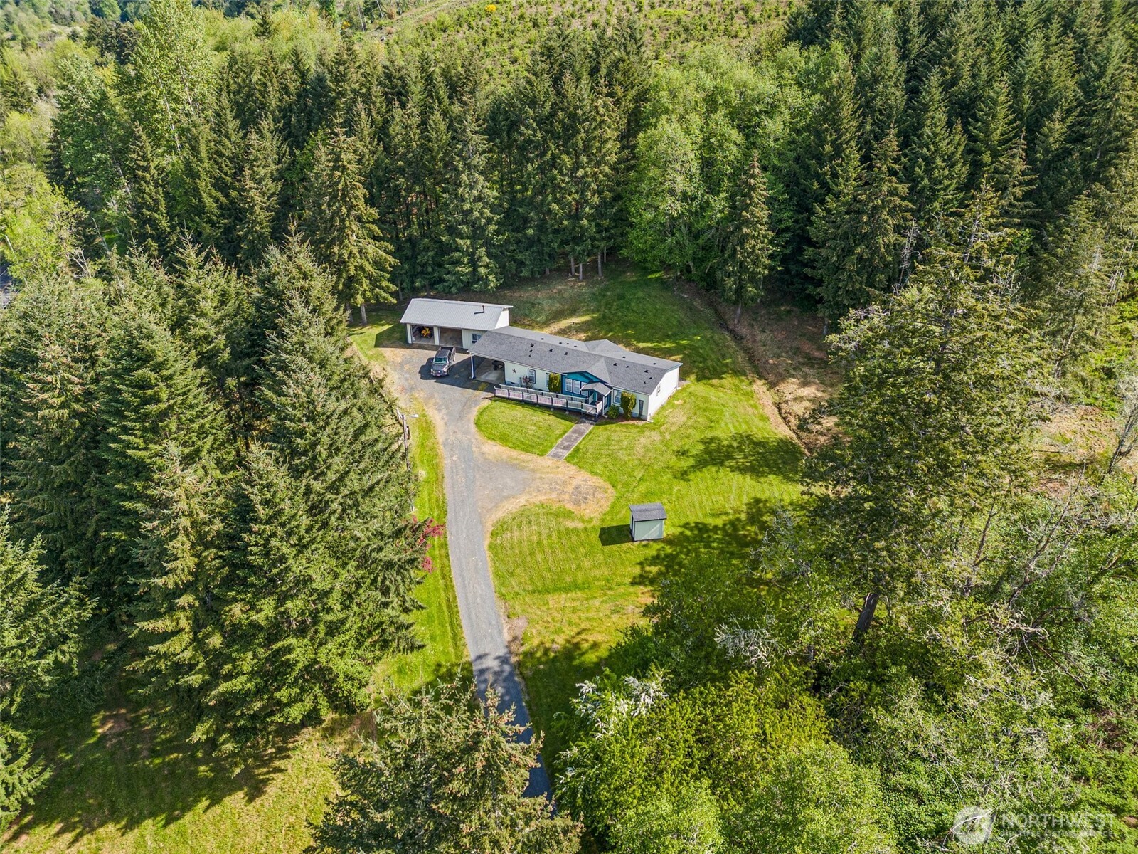 312 McGlaughlin Road Winlock, WA 98596 - Photo 2 of 40 a view of a house with a yard and large trees